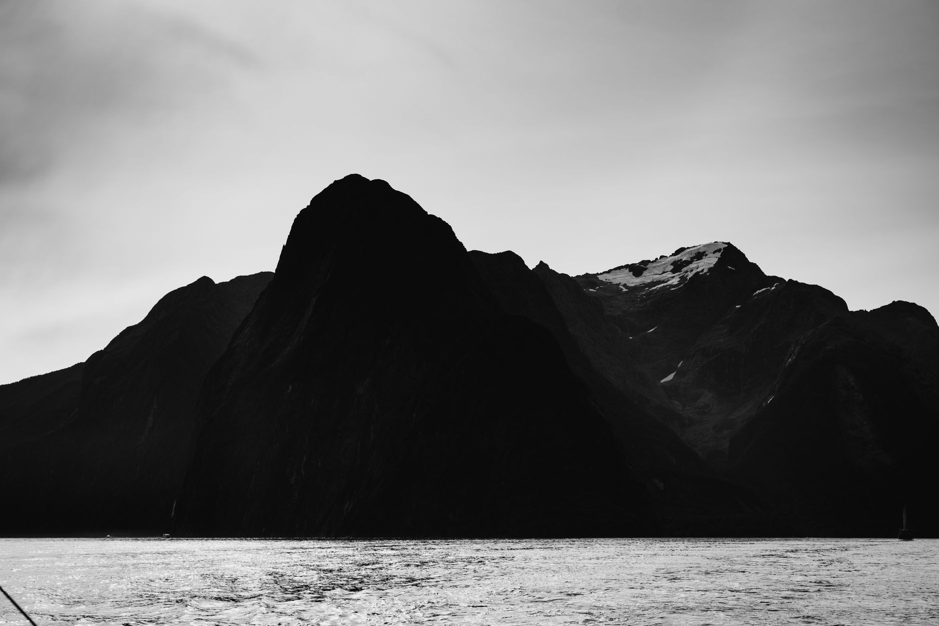 Milford Sound waterfalls cascading into emerald fiord waters